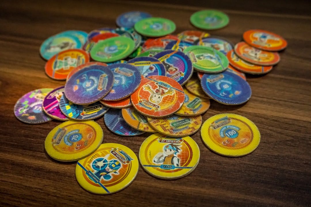 a pile of badges sitting on top of a wooden table